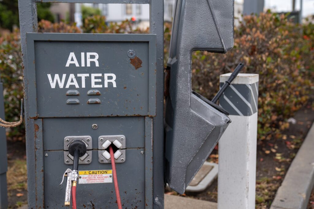 Air water pump refill stand and nozzle for tires at a gas station